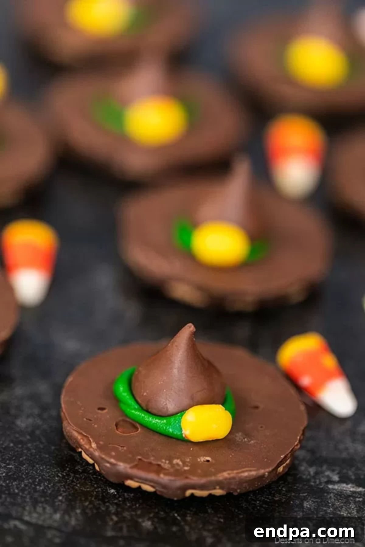Delicious Witch Hat Cookies displayed with candy corn, ready for a Halloween party.