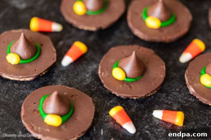 Finished Witch Hat Cookies with yellow candy corn buckles on the green icing.