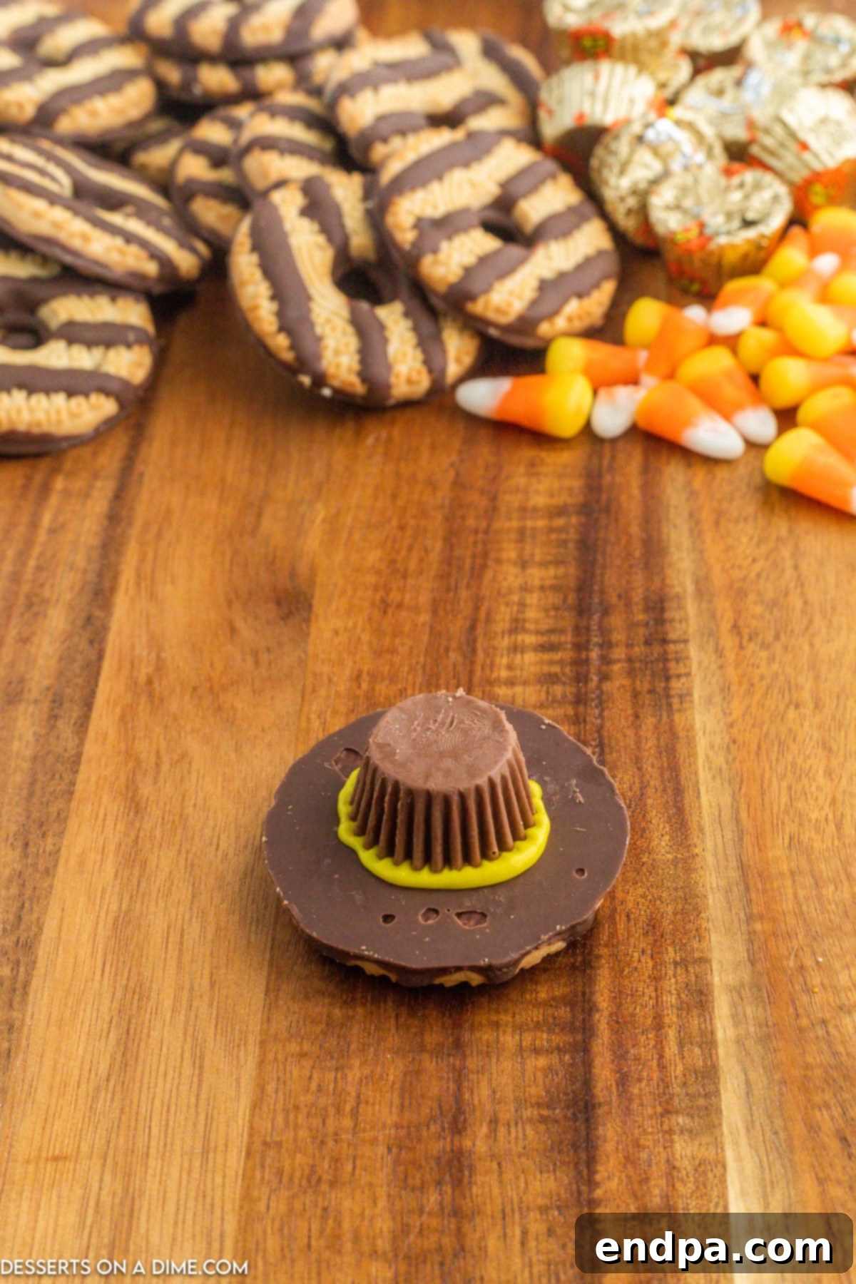 Mini Reese's Peanut Butter Cup gently pressed onto the yellow icing on the cookie.