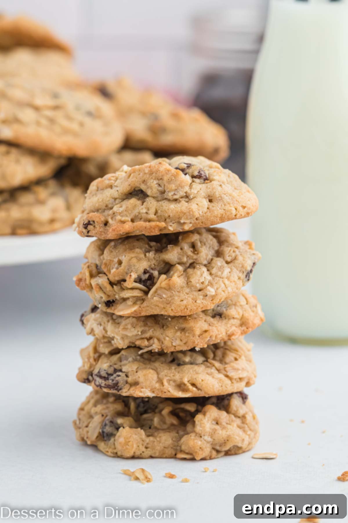 This is the best recipe for soft and chewy Oatmeal raisin cookies. They are so decadent and everyone will think you bought them at a bakery. Make these moist homemade cookies today for an easy treat. A beautiful stack of oatmeal raisin cookies, highlighting their soft texture and the generous amount of raisins, ready to be enjoyed.