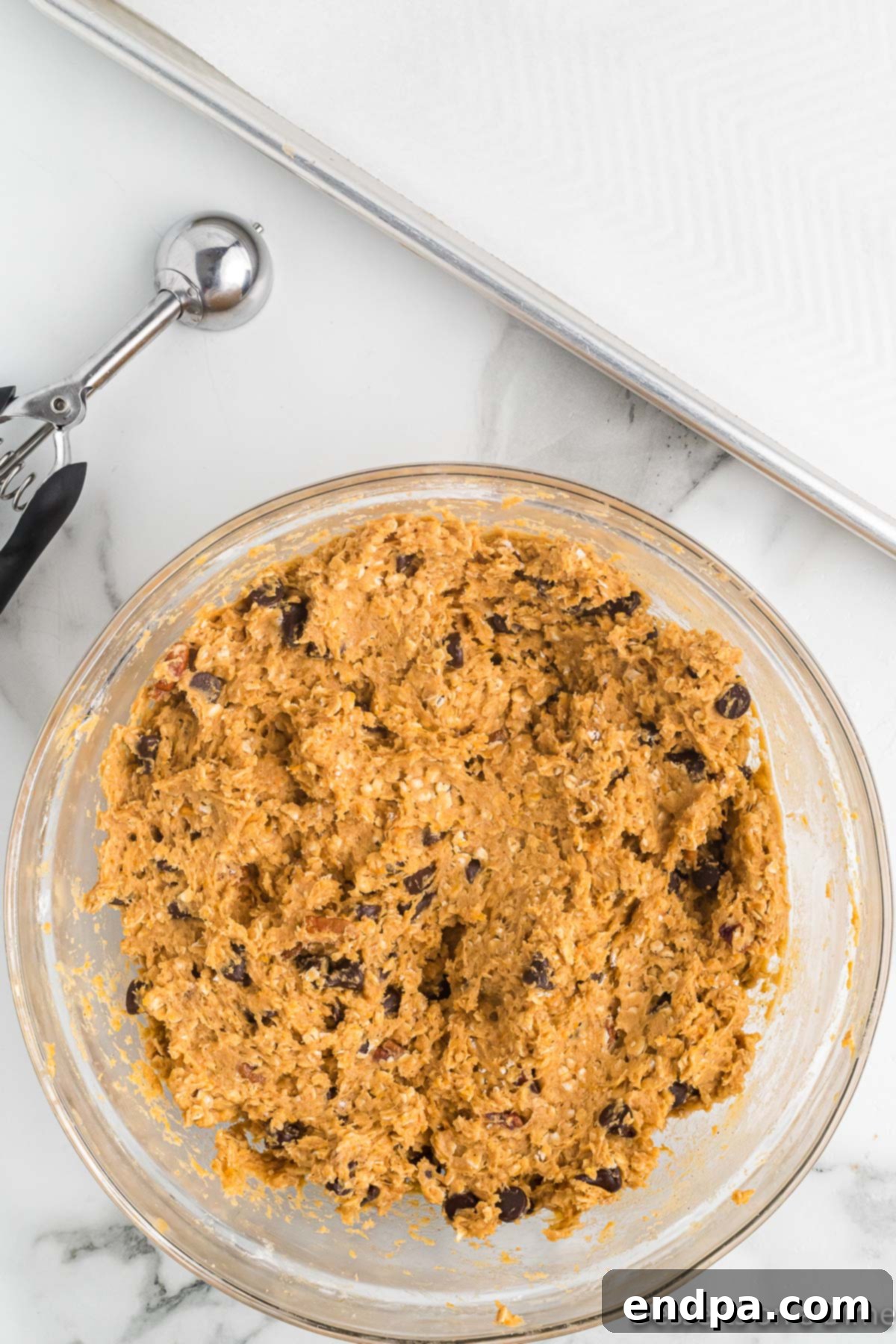 Golden Sweet Potato Cookies 11 Chocolate chips and chopped pecans being folded into the cookie dough.