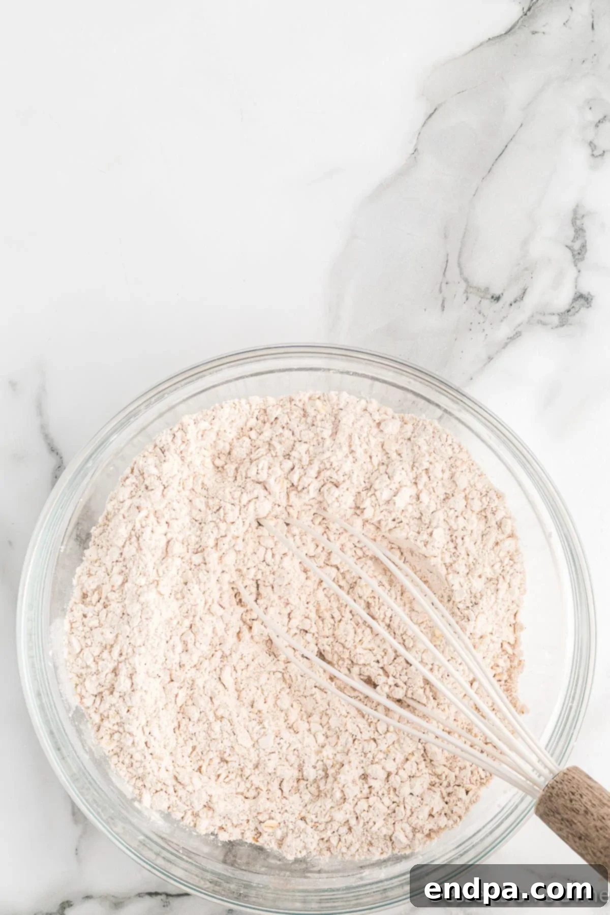 Golden Sweet Potato Cookies 7 All dry ingredients, including flour, oats, spices, and baking powder, mixed together in a bowl.
