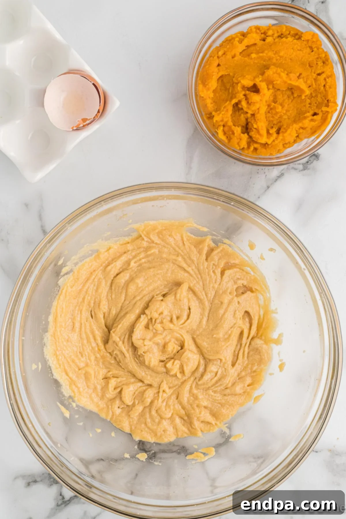 Golden Sweet Potato Cookies 9 Creamed butter and sugar mixture with an egg added to the bowl, ready for mixing.
