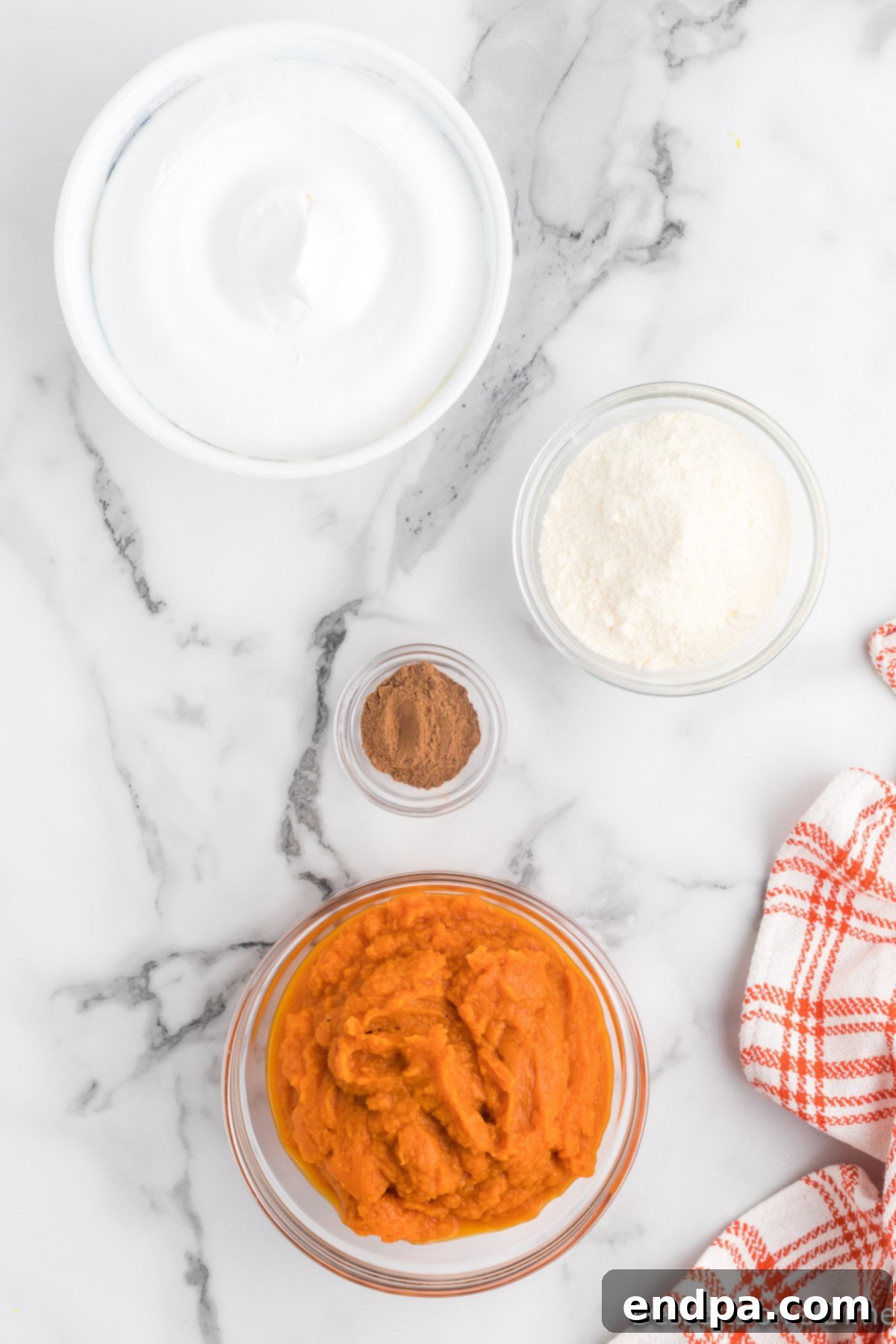 Autumn Pumpkin Fluff Dip 3 Essential ingredients for an easy pumpkin dip: a can of pumpkin puree, a box of instant vanilla pudding mix, a jar of pumpkin pie spice, and a tub of thawed whipped topping (Cool Whip).