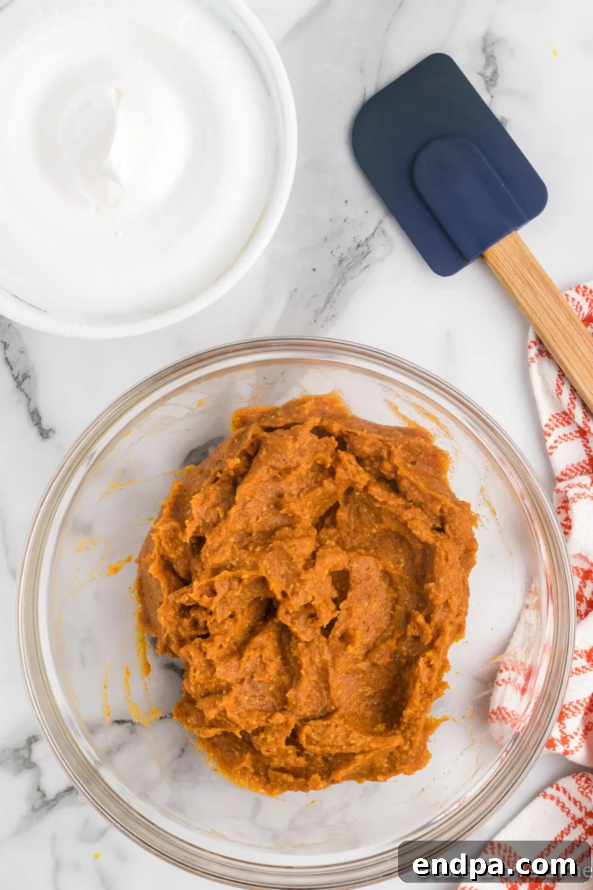 Autumn Pumpkin Fluff Dip 5 The combined pumpkin puree, vanilla pudding mix, and pumpkin pie spice in a mixing bowl, showing a smooth and well-blended texture.