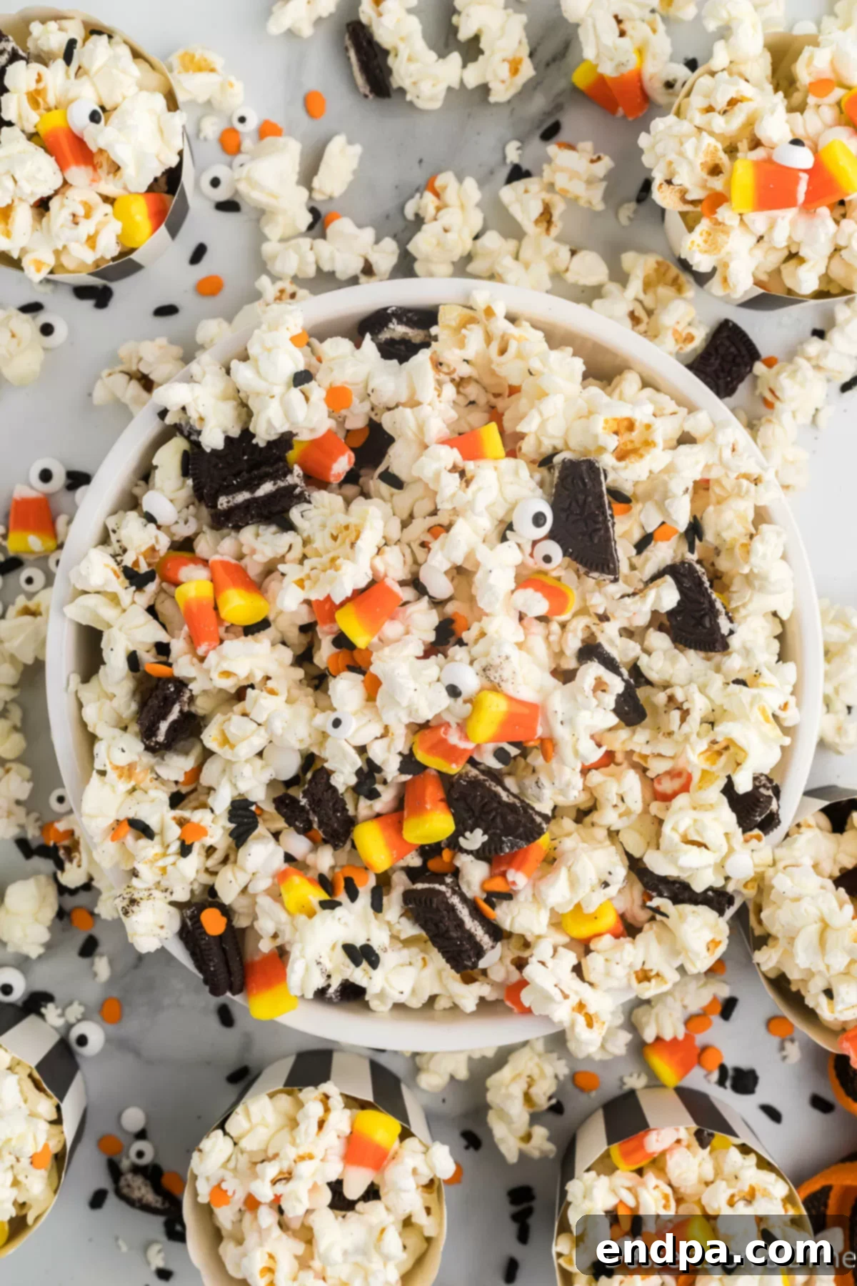 Haunted Kernels 9 A bowl of Halloween Popcorn, with white chocolate, Oreos, candy corn, and candy eyes visible.