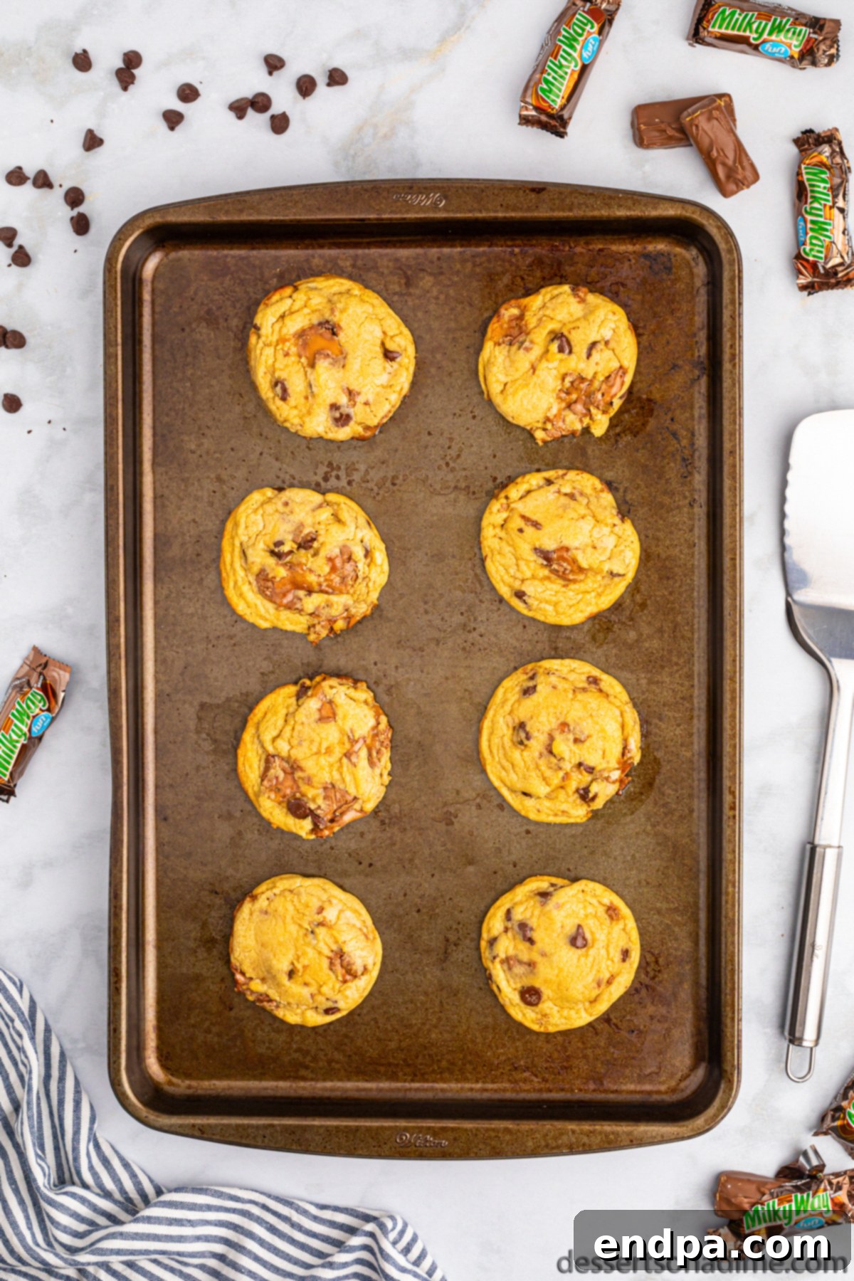 Nougat Caramel Dream Cookies 11 Freshly baked Milky Way Cookies cooling on the baking sheet before being moved to a wire rack.
