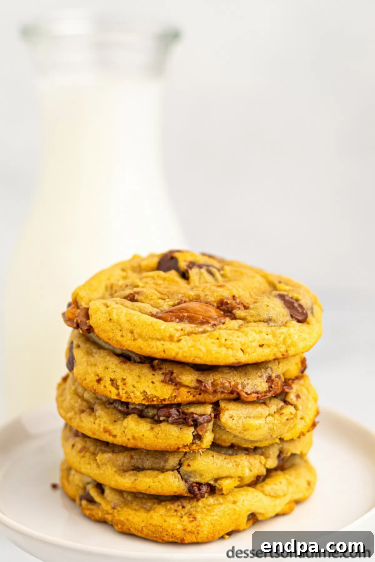 Nougat Caramel Dream Cookies 12 A close-up shot of multiple Milky Way Cookies, some stacked, showcasing their gooey centers and rich topping.