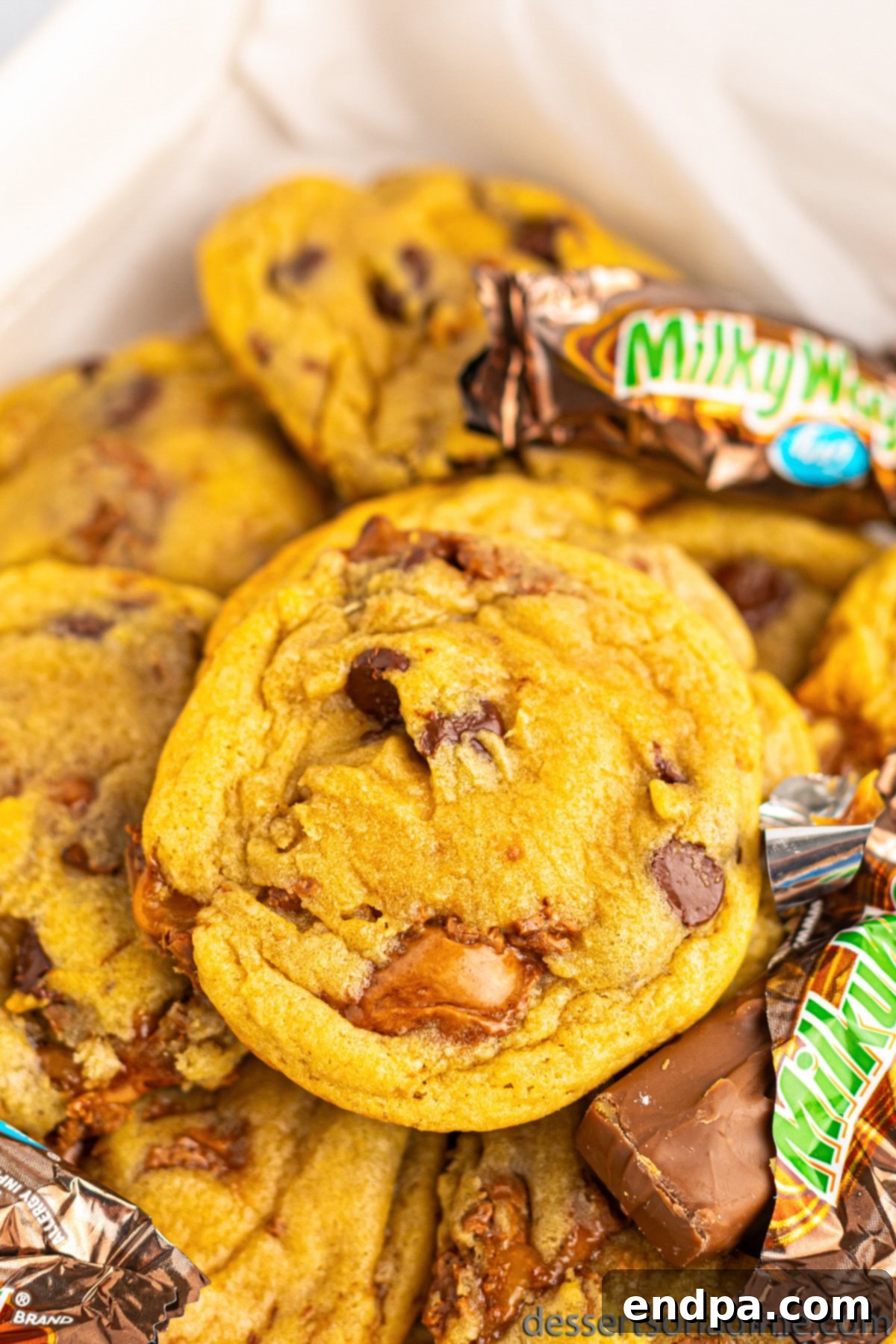 Nougat Caramel Dream Cookies 13 A plate of freshly baked Milky Way Cookies, perfectly golden brown and inviting.