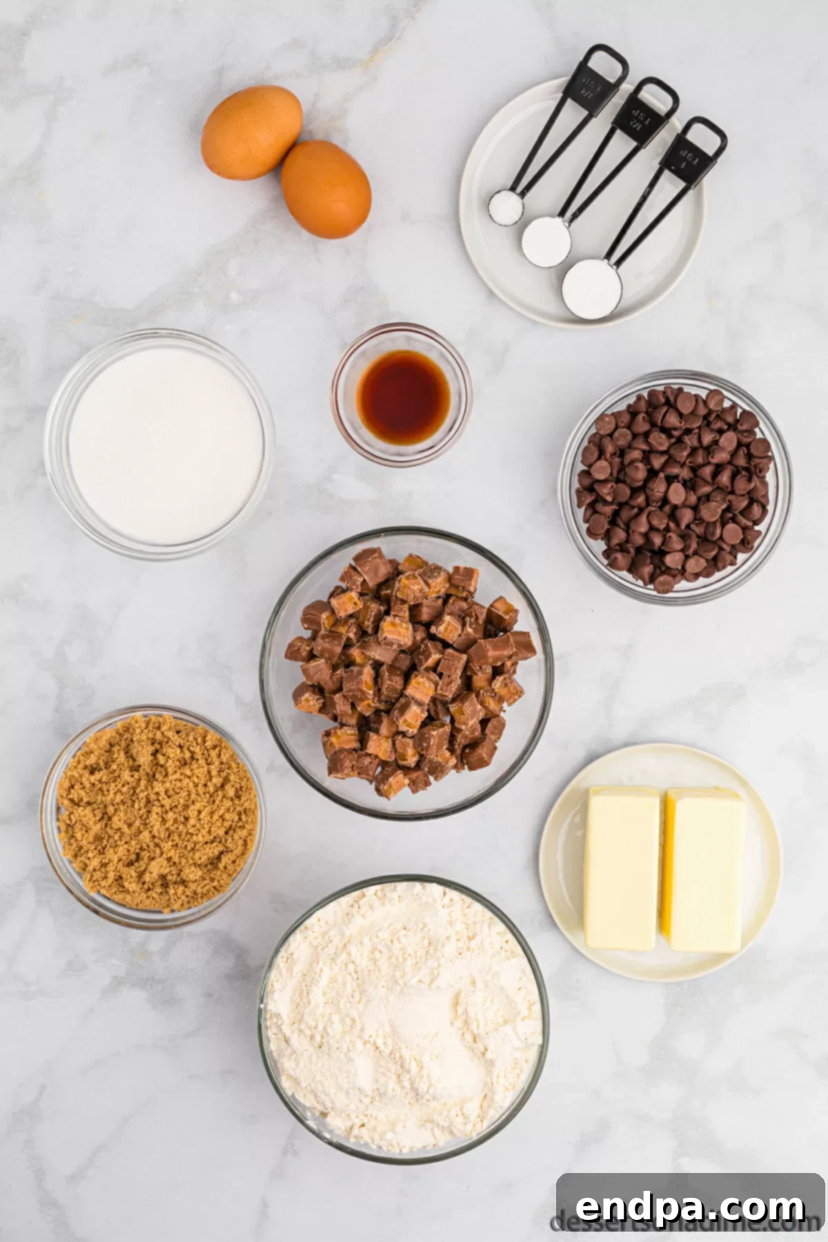 Nougat Caramel Dream Cookies 3 All the essential ingredients for making Milky Way Cookies laid out, including softened butter, sugars, eggs, salt, chocolate chips, and chopped Milky Way candy bars.