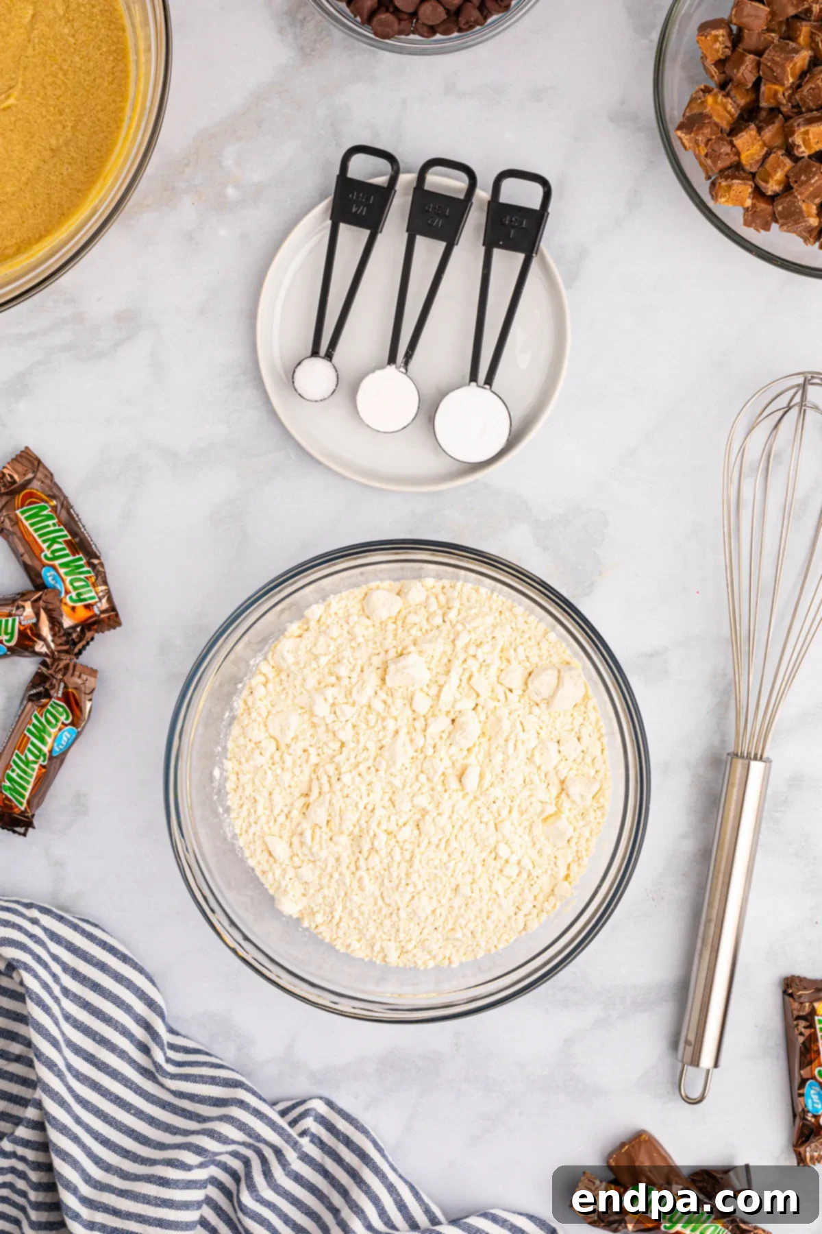 Nougat Caramel Dream Cookies 6 A separate bowl containing all-purpose flour, baking soda, baking powder, and salt, whisked together.