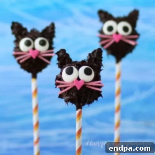 Spooktacular Cake Pops 9 Adorable black cat cake pops with pointed ears and vibrant green eyes, filled with peanut butter fudge.
