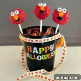 Spooktacular Cake Pops 12 Cute Monster Elmo cake pops, bright red with googly eyes, perfect for a friendly Halloween treat.