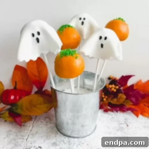 Spooktacular Cake Pops 13 Gluten-free ghost cake pops with simple white coating and edible ghost faces, standing in a holder.