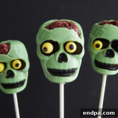 Spooktacular Cake Pops 15 Zombie cake pops with skull-shaped white chocolate shells and a hint of red velvet 'brains' inside.