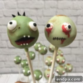 Spooktacular Cake Pops 16 Zombie cake pops featuring detailed facial features drawn with edible pens on a white chocolate coating.