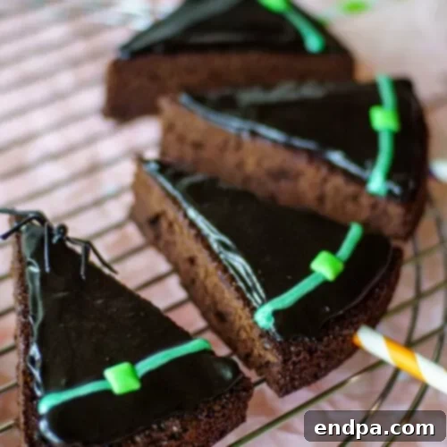 Spooktacular Cake Pops 17 Witch hat brownie pops, designed with dark hats and colorful accents, standing vertically.