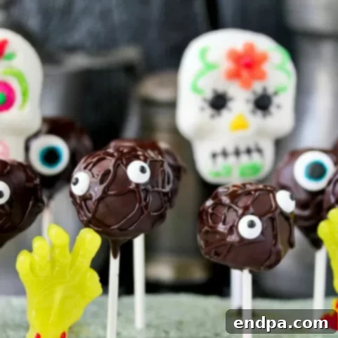 Spooktacular Cake Pops 6 Dark chocolate monster cake pops with various colored frosting and multiple candy eyes, standing upright.