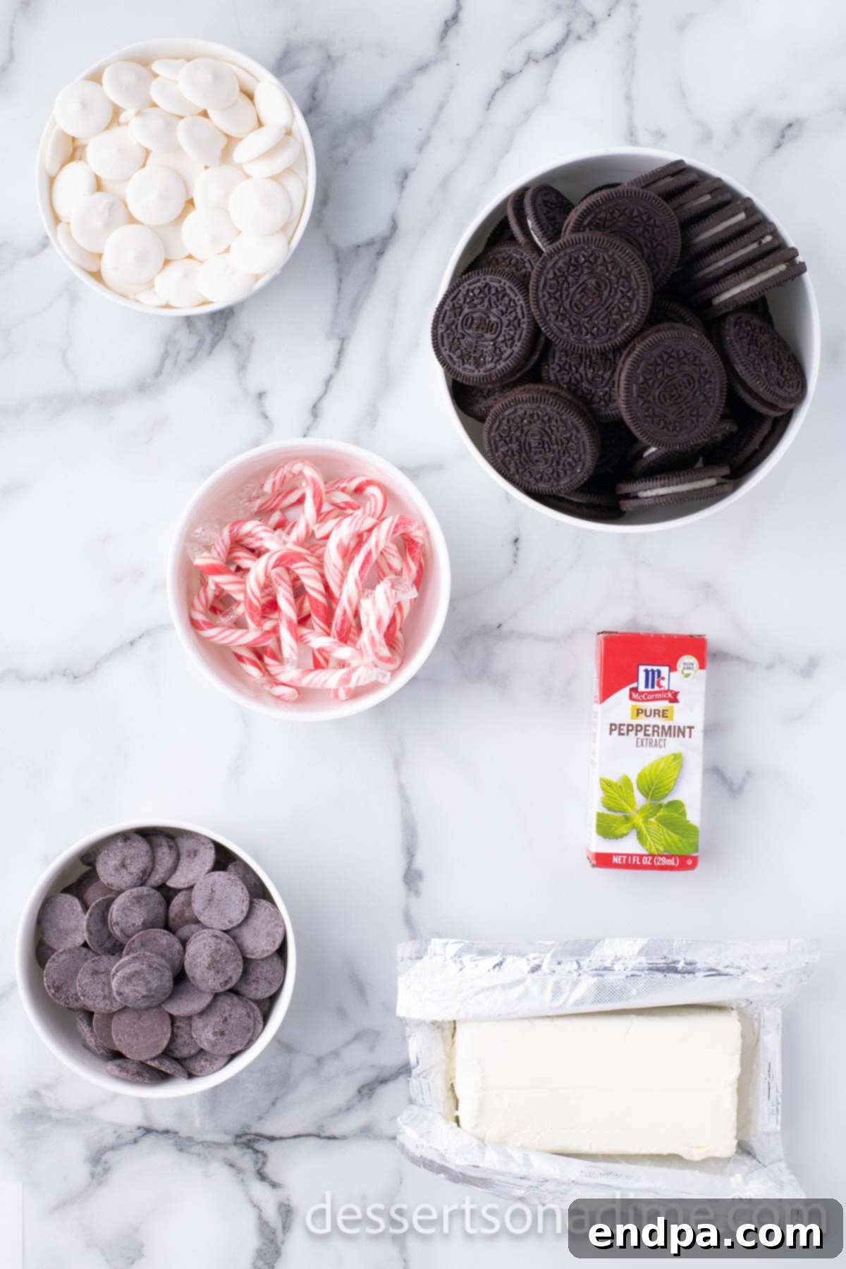 Cool Mint Oreo Truffles 3 Ingredients for Peppermint oreo balls - cream cheese, oreo cookies, peppermint extract, candy wafers, candy canes displayed on a rustic wooden board.