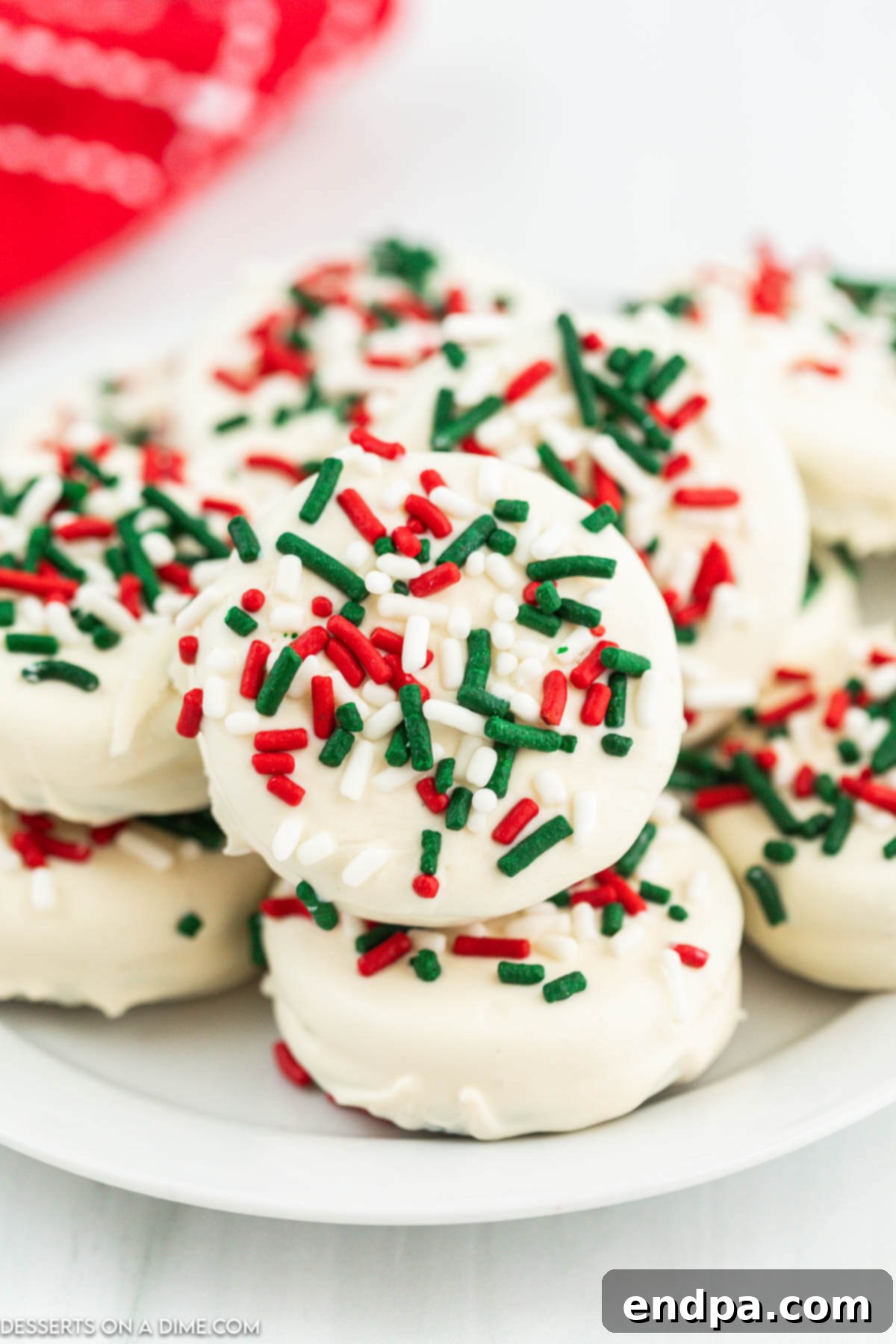 Holiday Oreo Delights 2 Platter of Christmas white chocolate Oreos, decorated with red and green sprinkles, ready for serving.