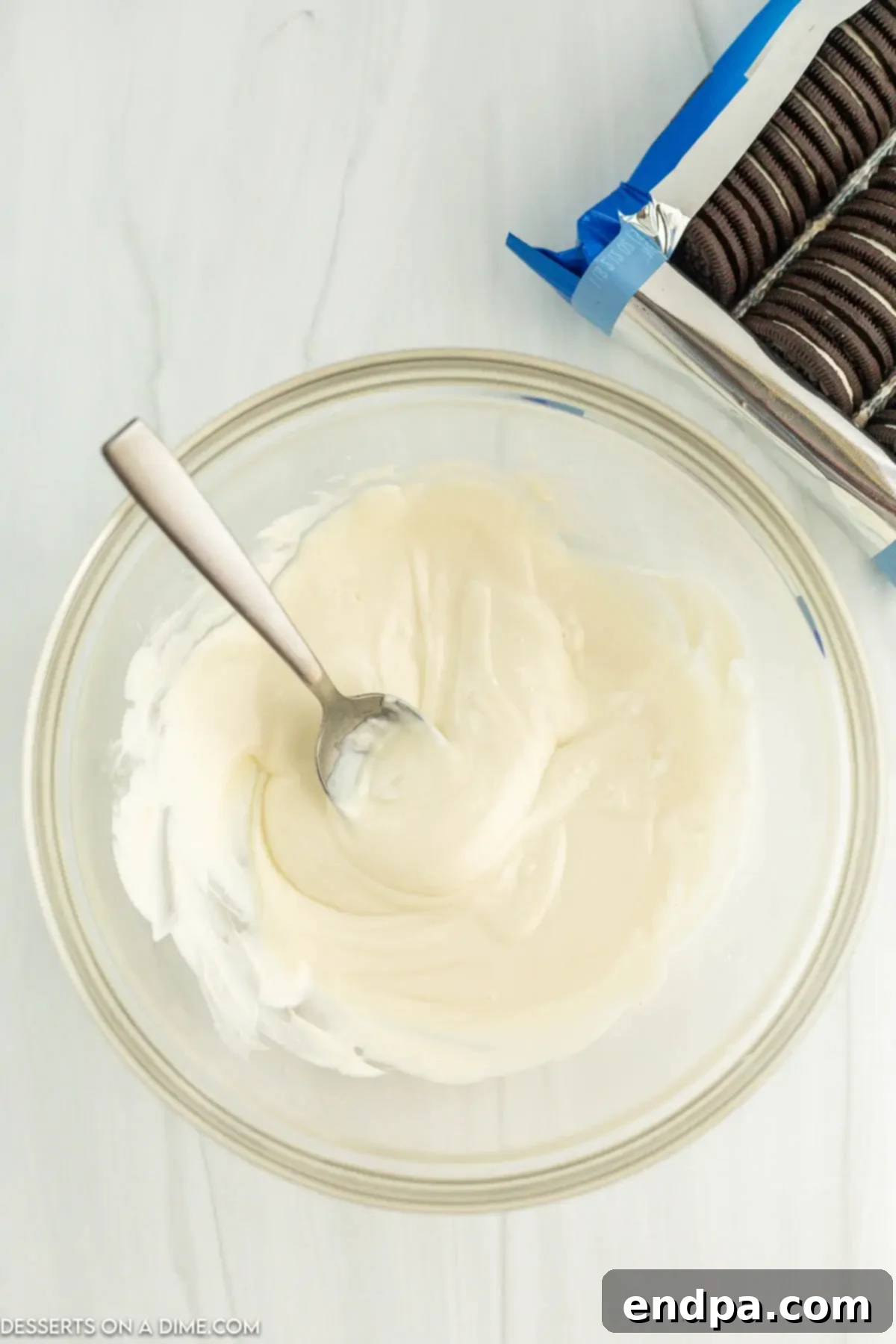 Holiday Oreo Delights 4 White candy melts and vegetable oil in a microwave-safe bowl, ready to be melted.