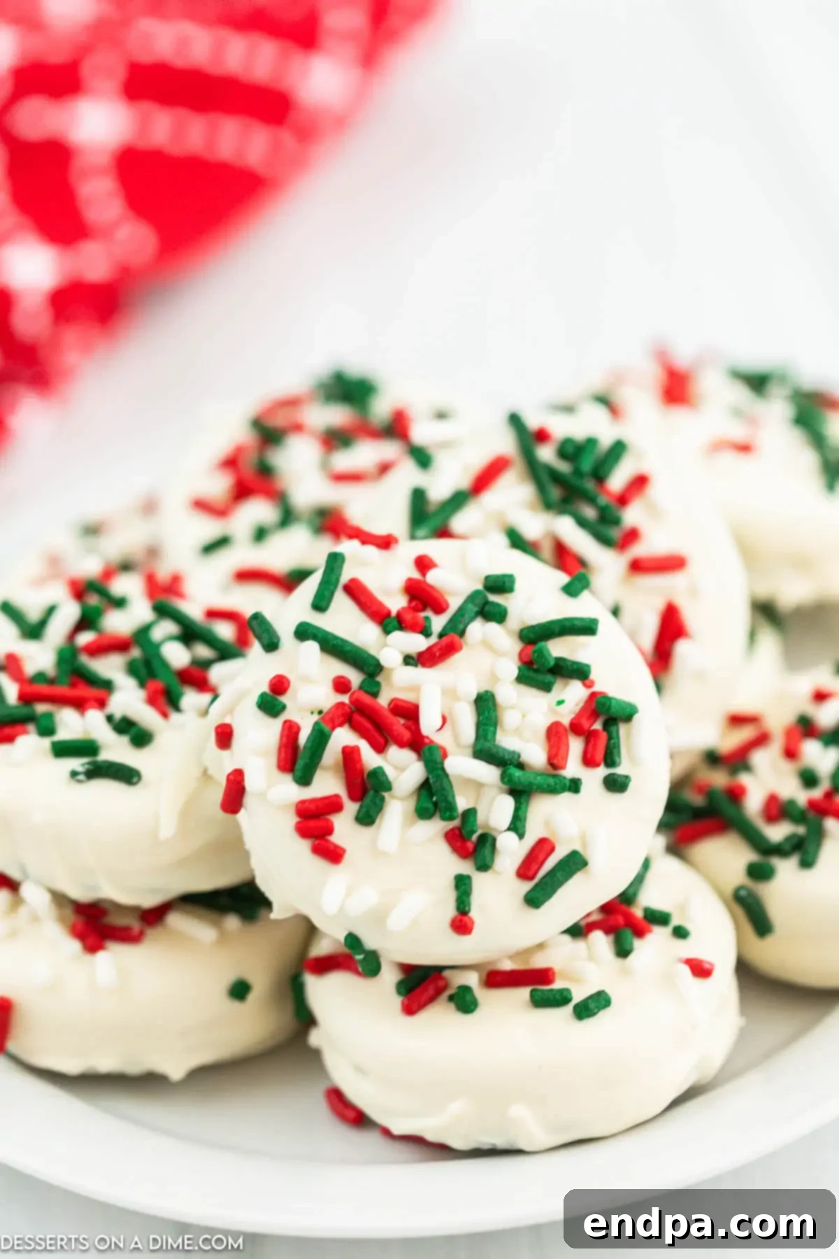 Holiday Oreo Delights 8 Close-up of a platter filled with festive Christmas White Chocolate Oreos, ready to be served at a holiday party.