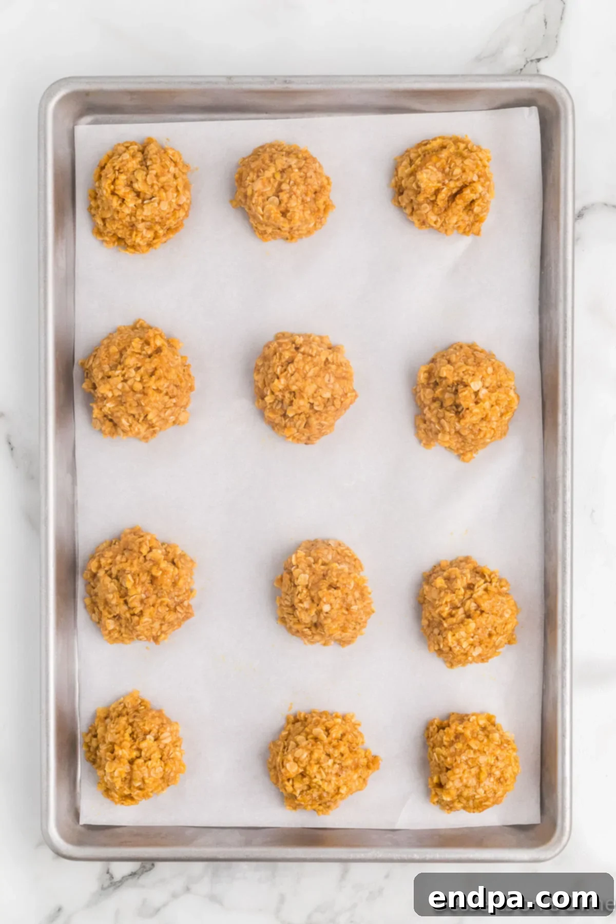 Autumn Pumpkin Spice Delights 7 Scoops of cookie mixture placed neatly on a baking sheet lined with parchment paper.