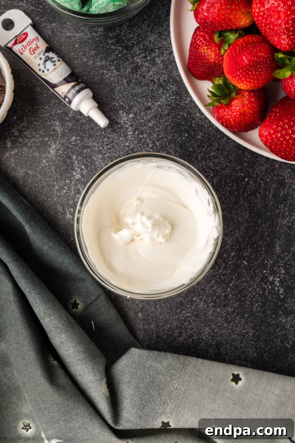 Melted candy wafers in separate microwave-safe bowls, ready for dipping.