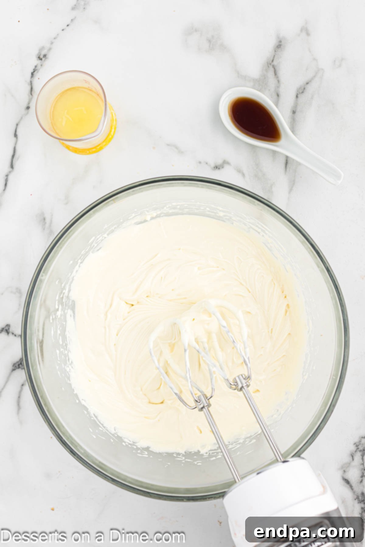 Simple No-Bake Cheesecake Dream 7 Mixing bowl with filling ingredients being combined.