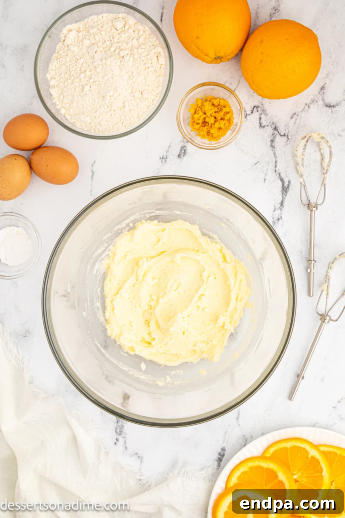 Softened butter and granulated sugar are creamed together in a mixing bowl until light and fluffy.