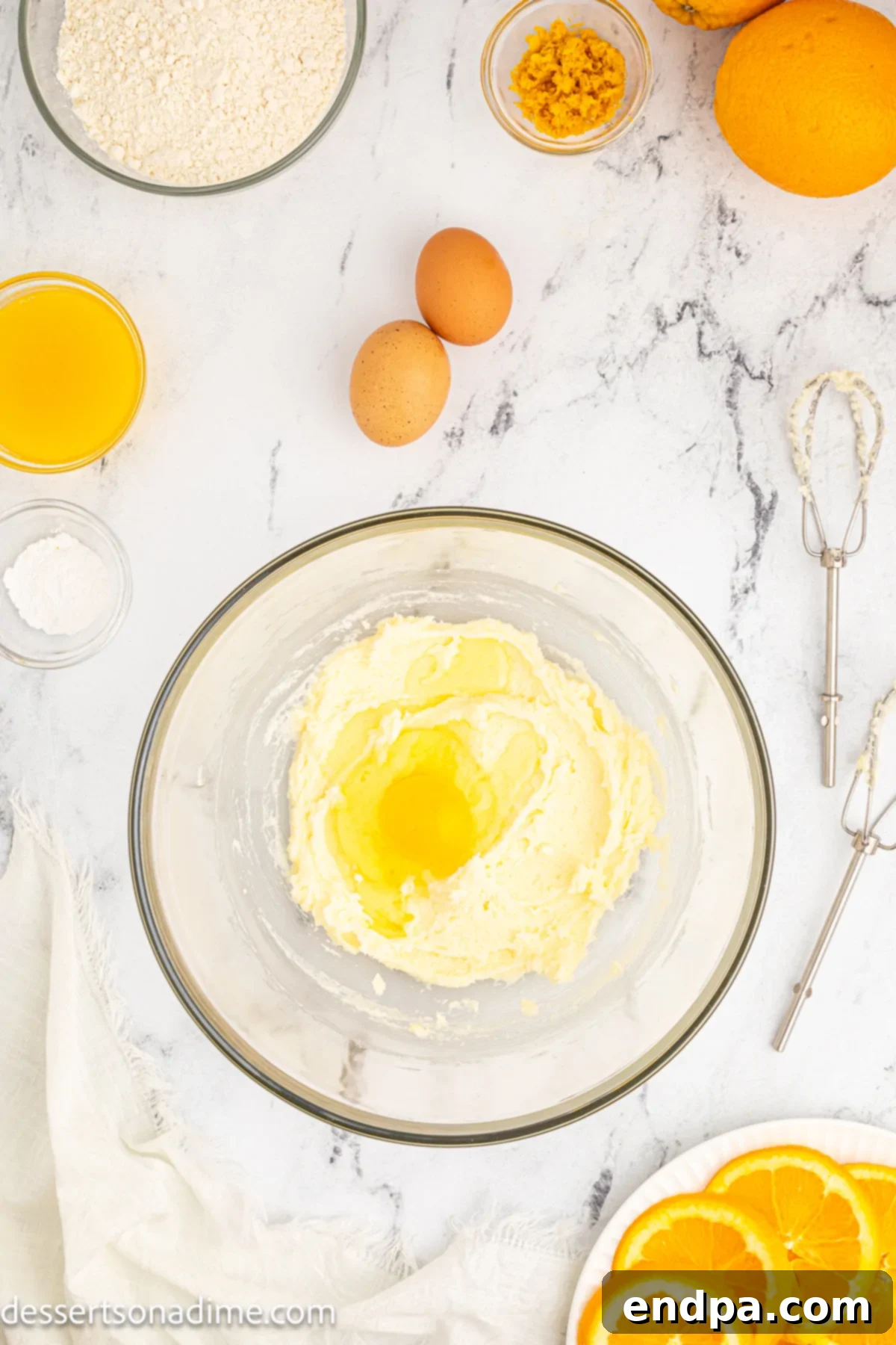 Eggs are gradually mixed into the creamed butter and sugar mixture.