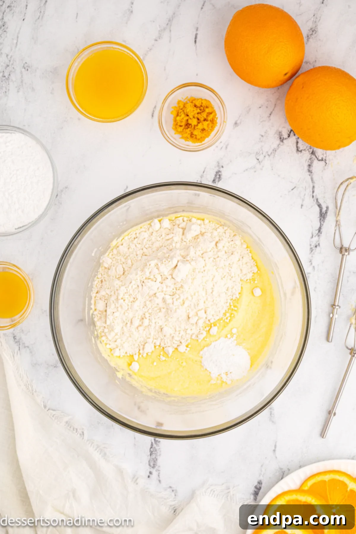 Dry ingredients, including flour, are gently folded into the wet batter.