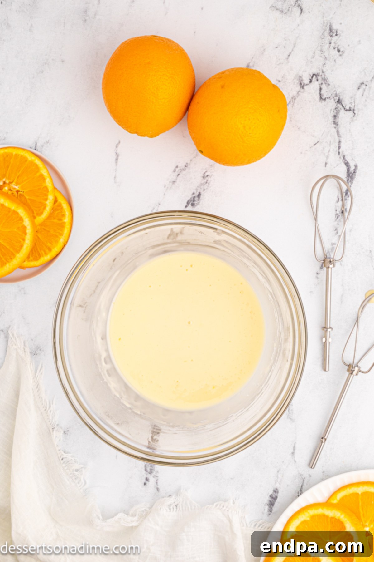 Ingredients for the orange glaze, powdered sugar and orange juice, are combined in a bowl.