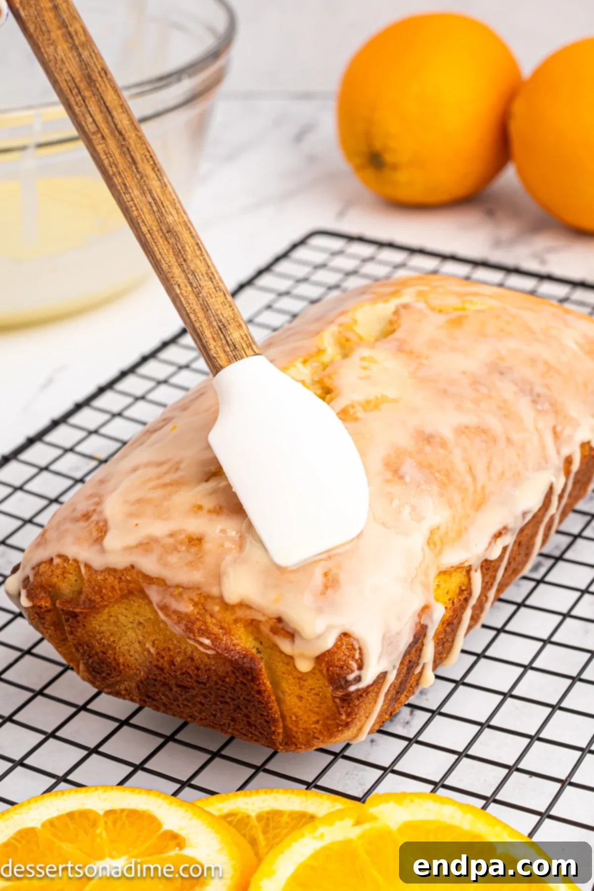 The orange glaze is drizzled generously over the cooled pound cake.