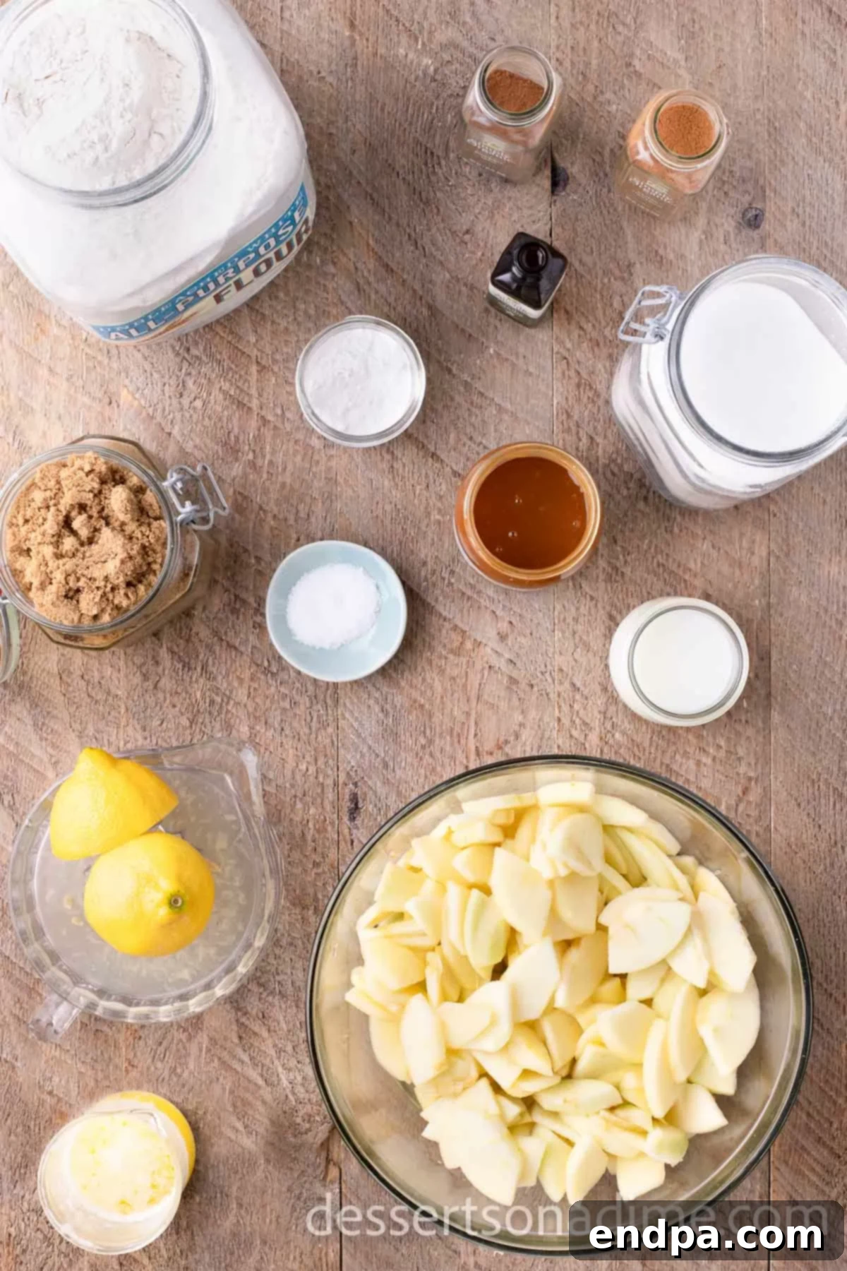 Ingredients for apple cobbler - apples, brown sugar, flour, lemon, cinnamon, nutmeg.