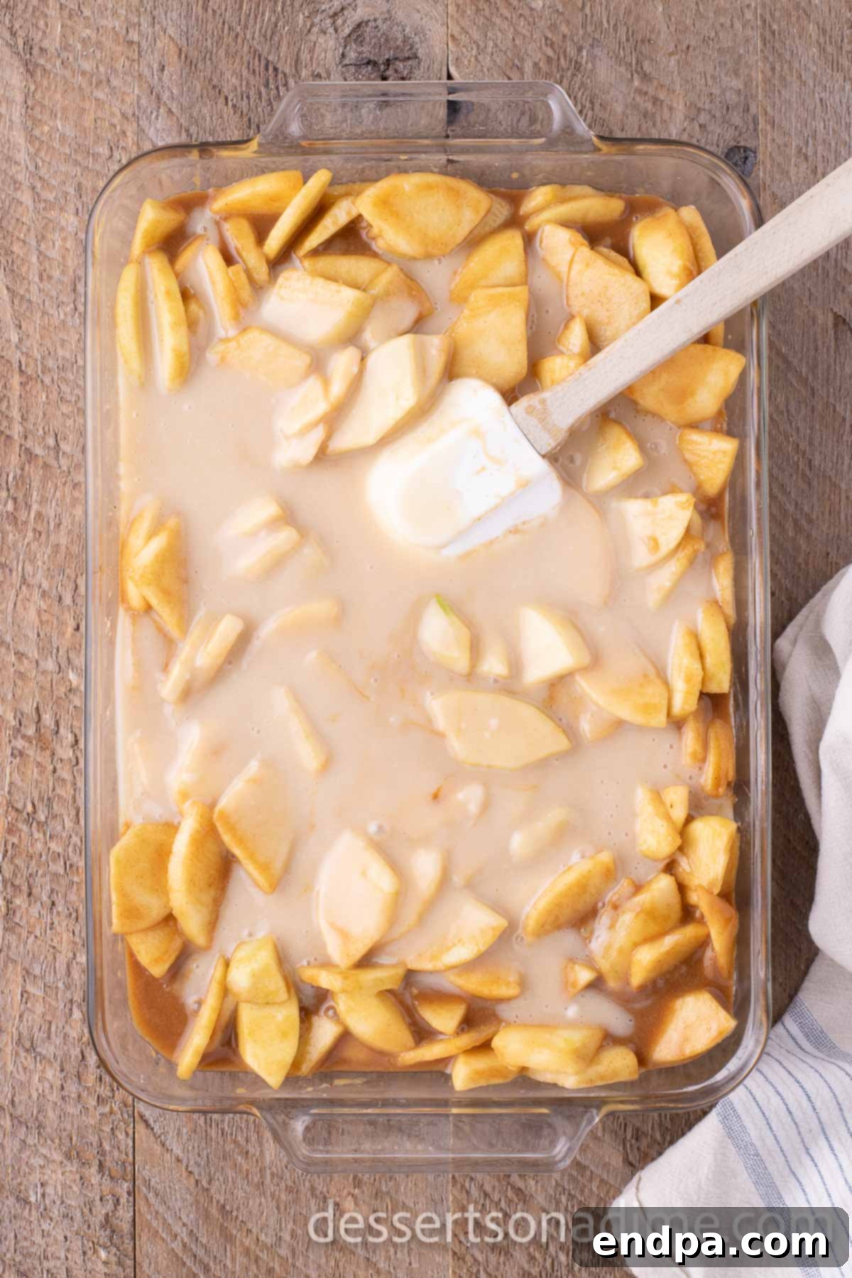 Topping mixture spread over apples in baking dish.