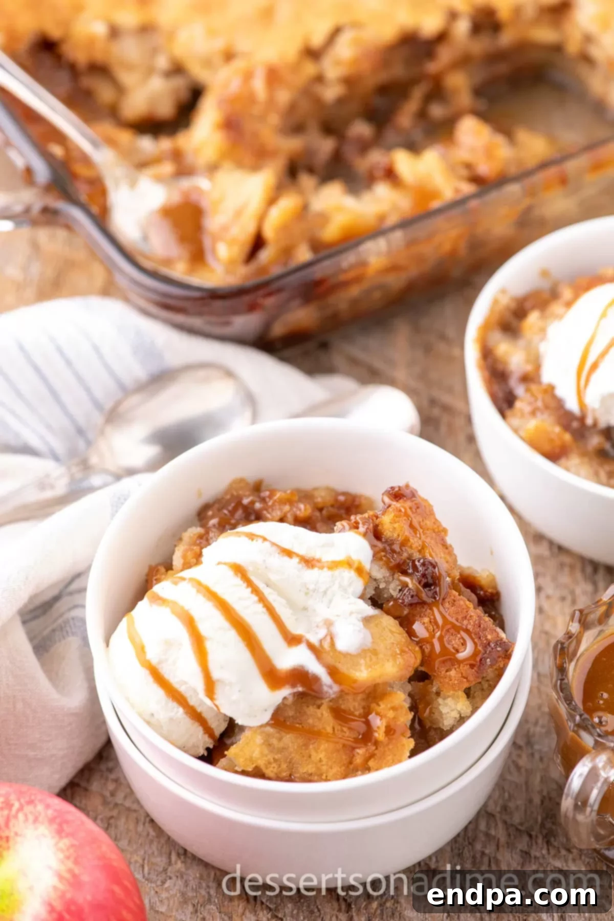 Caramel apple cobbler topped with ice cream.