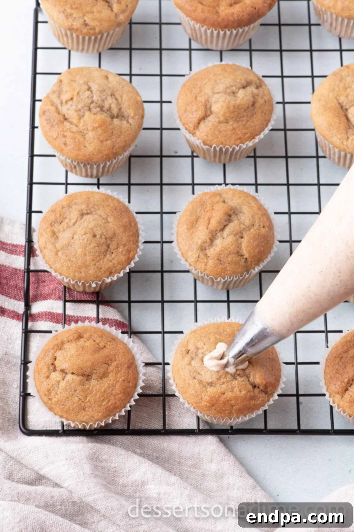 Cinnamon Sugar Swirl Cupcakes 11 Piping the frosting onto the cool cupcakes