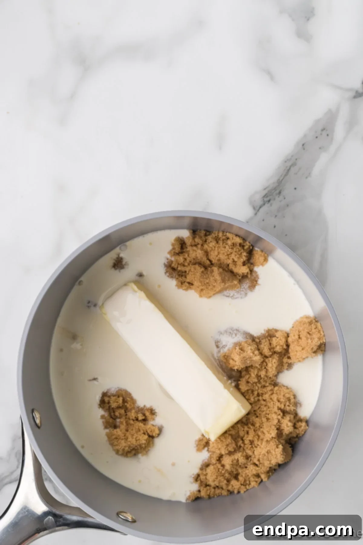 Decadent Homemade Caramel 4 Saucepan with butter, heavy cream and brown sugar combined.