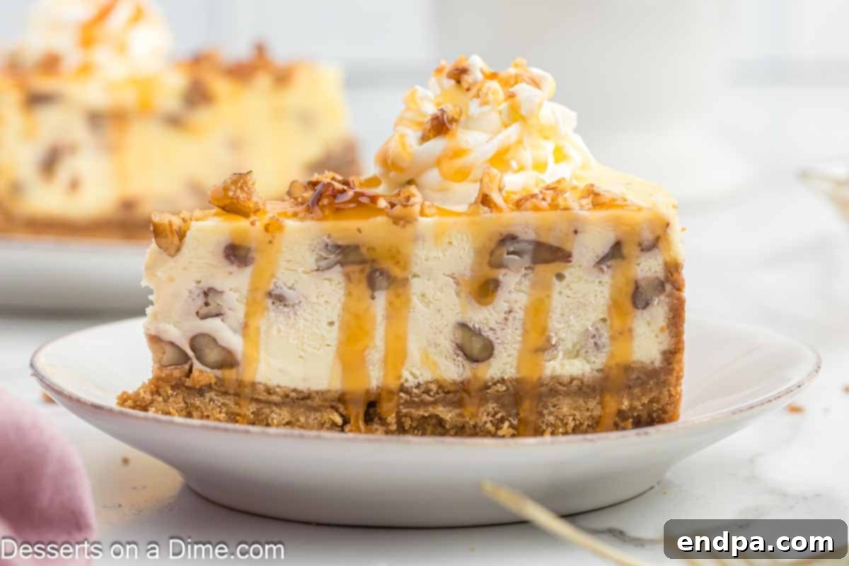 Golden Butter Pecan Cheesecake 2 A perfectly sliced piece of butter pecan cheesecake, showcasing its creamy filling and generous pecan topping, resting elegantly on a white plate. This decadent dessert is ready to be enjoyed.