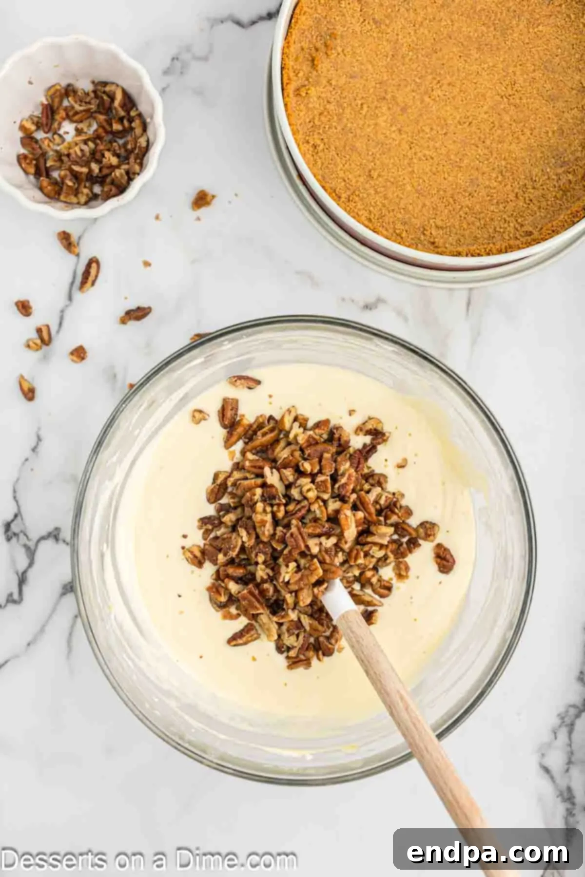 Golden Butter Pecan Cheesecake 10 Toasted pecans gently folded into the creamy cheesecake filling, ensuring an even distribution of nutty flavor throughout the batter.