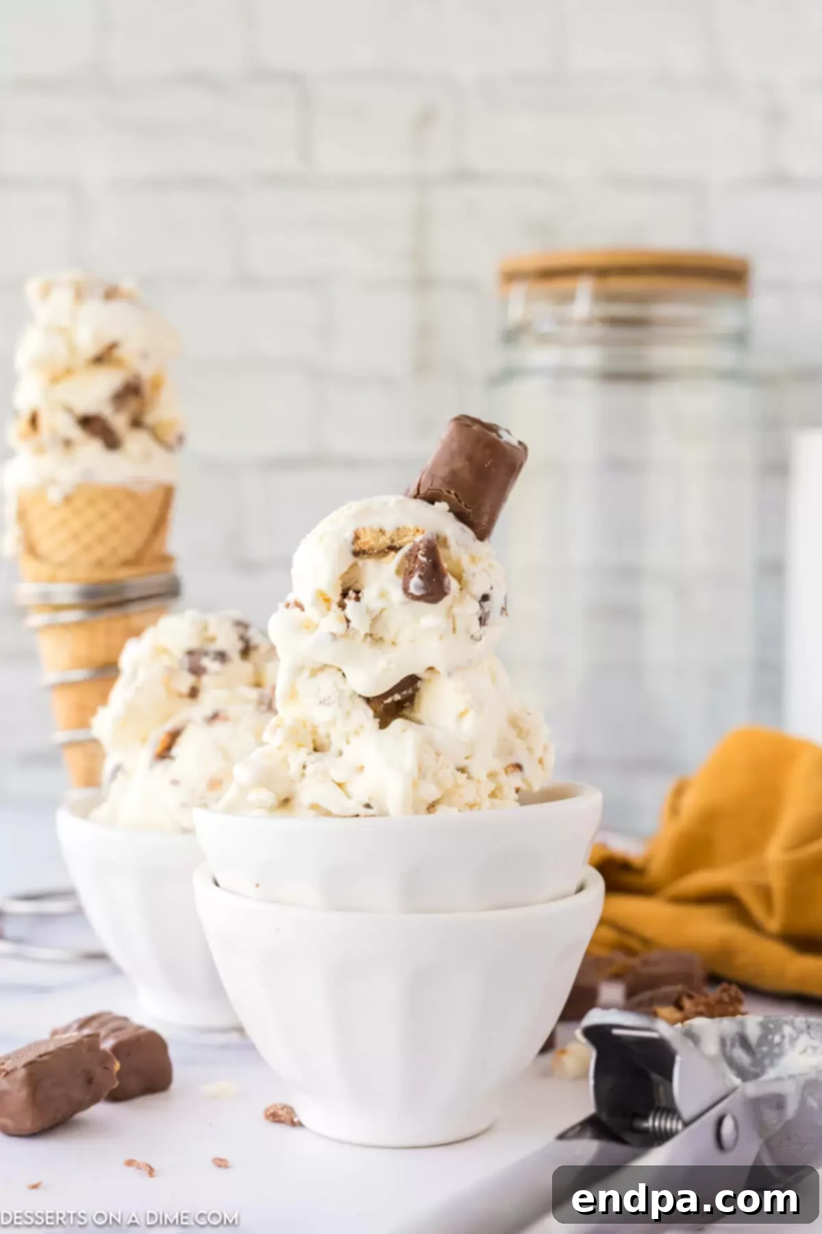 Delicious Twix Ice Cream in a bowl, showing chunks of chocolate, caramel, and biscuit.
