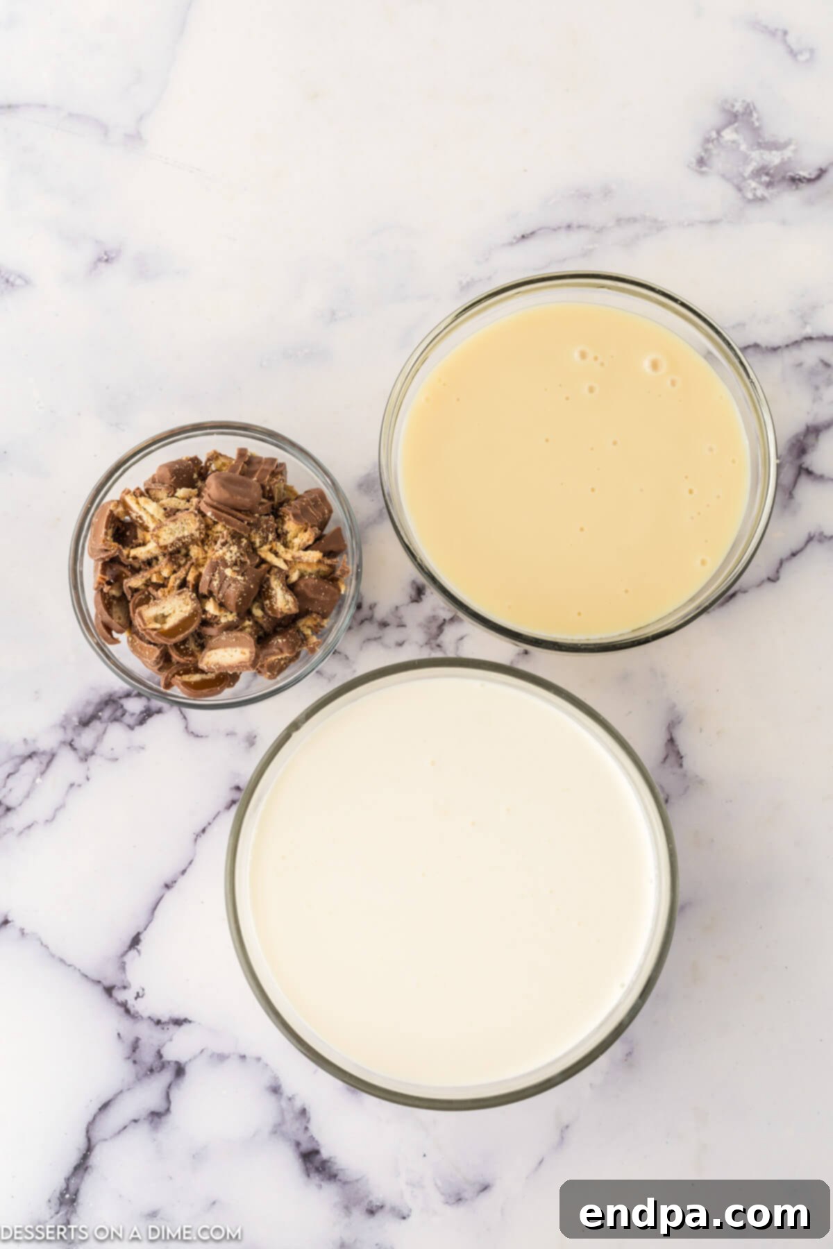 Ingredients for Twix ice cream: heavy cream, sweetened condensed milk, and chopped Twix bars.