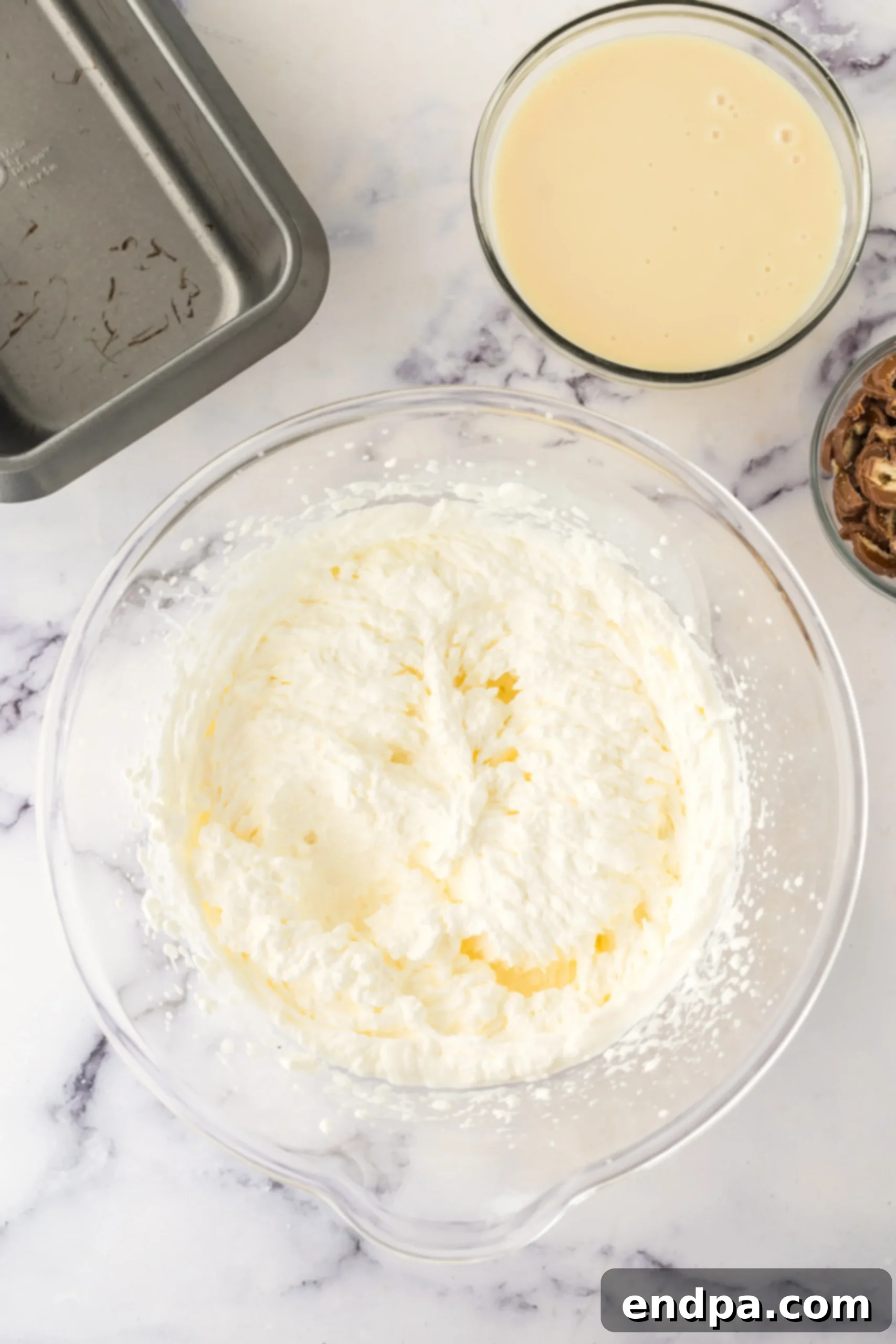 Whipping heavy cream in a large bowl with an electric mixer.