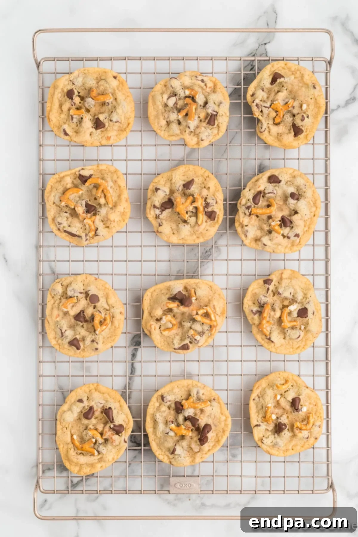 Baked pretzel cookies cooling on a wire rack after being removed from the oven.