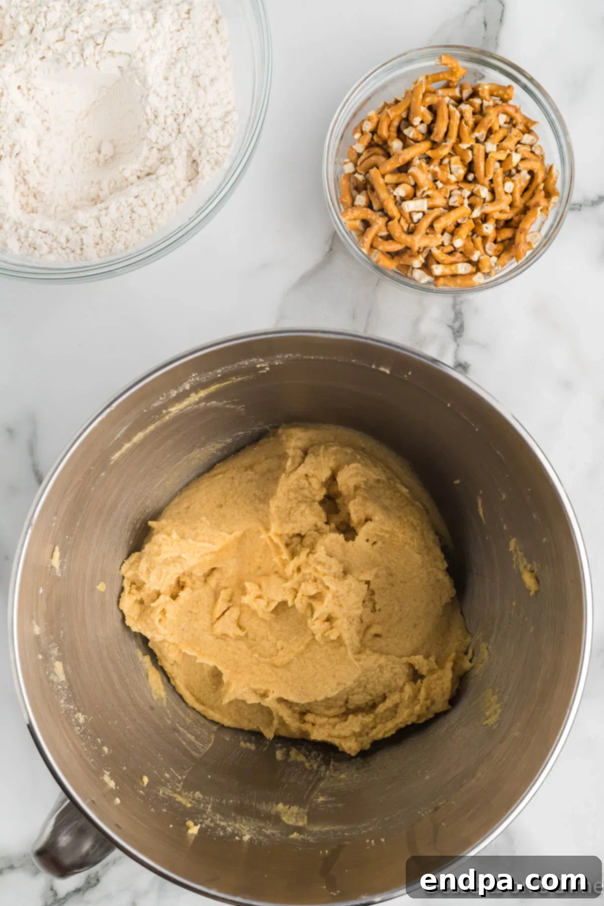 The process of slowly adding dry ingredients to the wet mixture in a mixer.