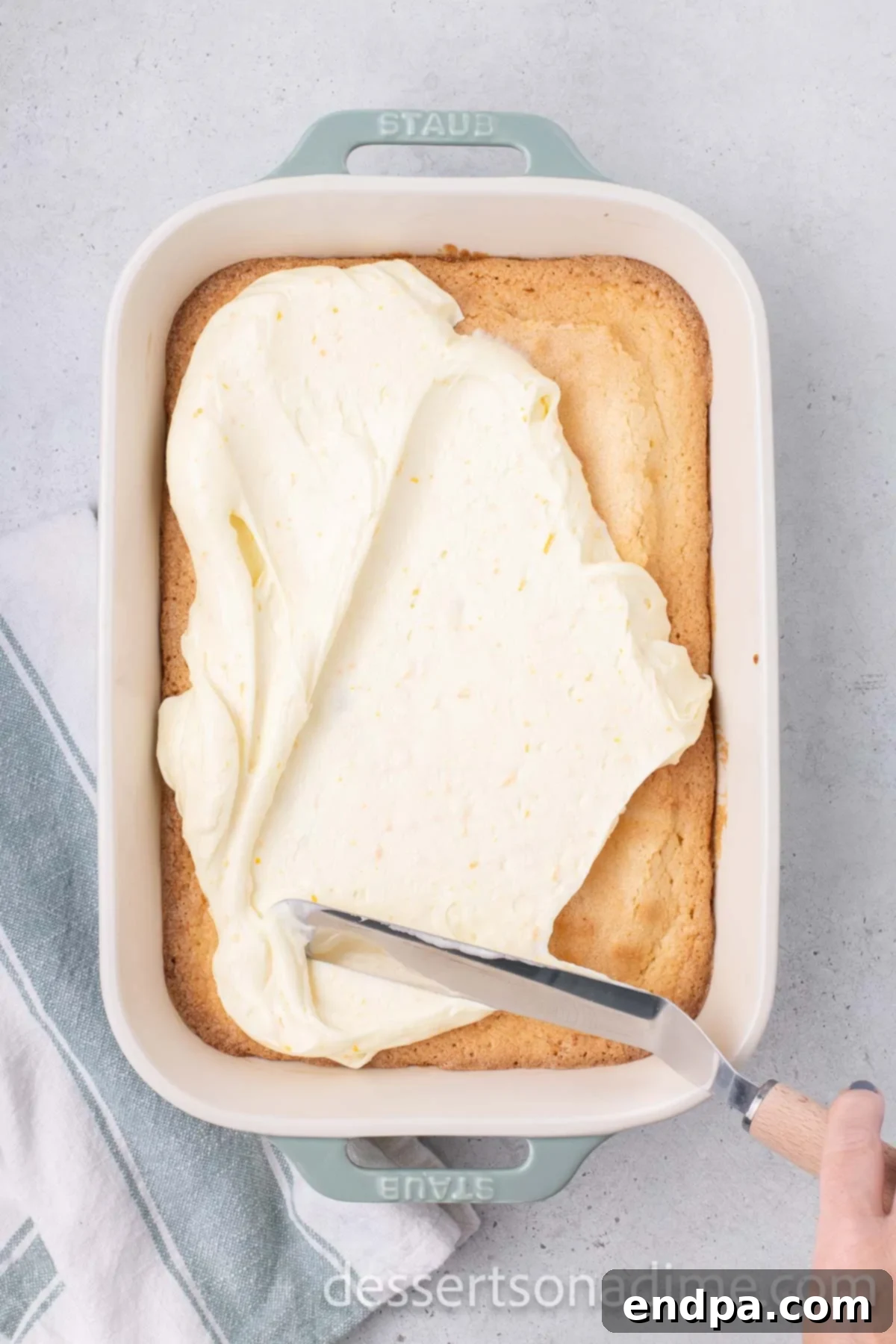 Orange Burst Brownies 13 Frosting spread over batter.