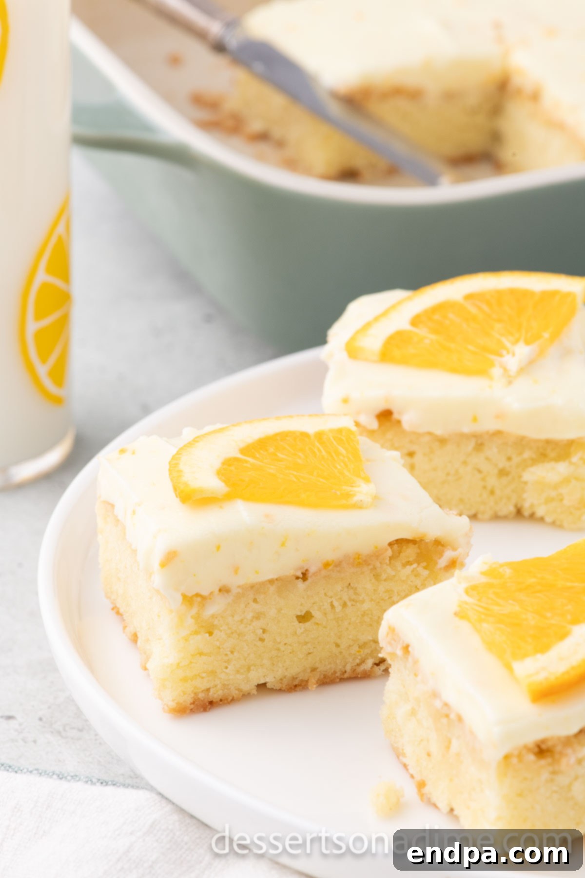 Orange Burst Brownies 14 Slice of Orange Brownie on a plate topped with orange slices