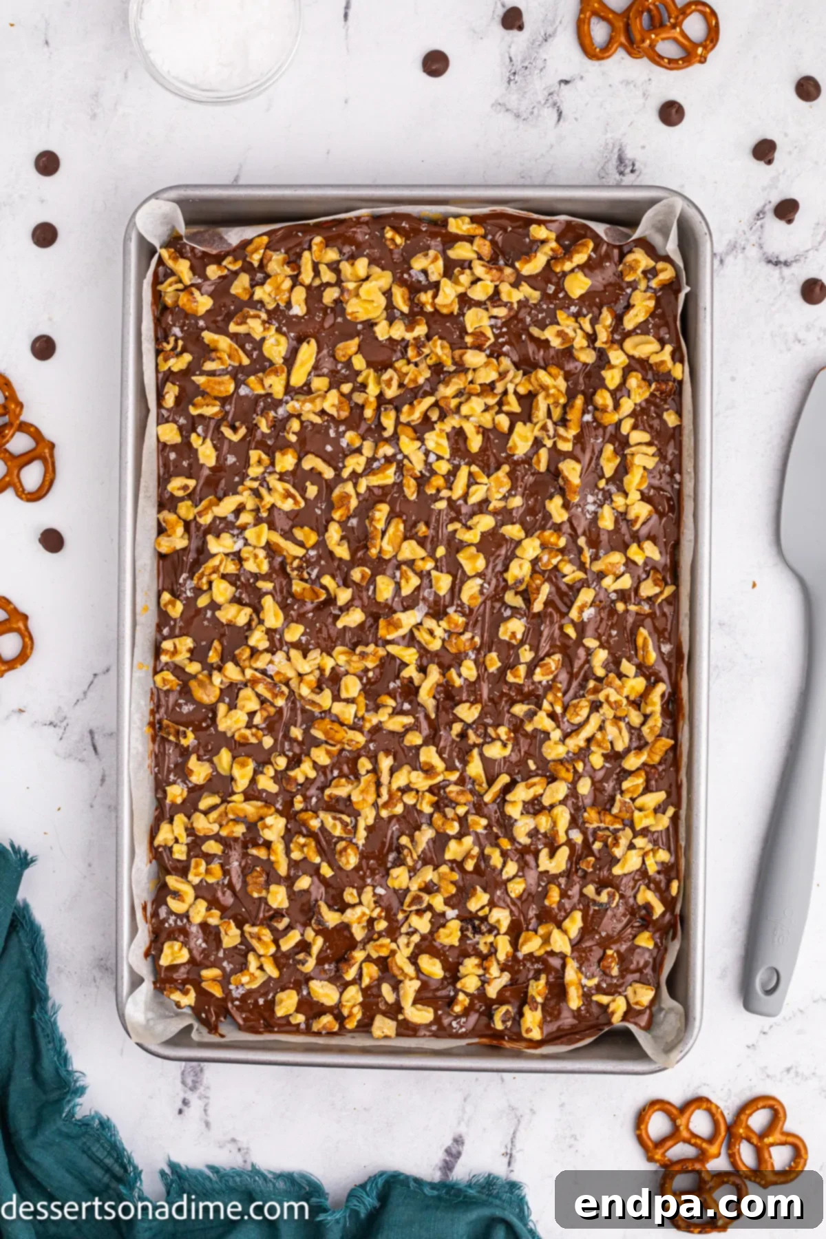 Twisted Toffee Treat 11 Chopped nuts and sea salt sprinkled over the freshly spread chocolate on the pretzel toffee.