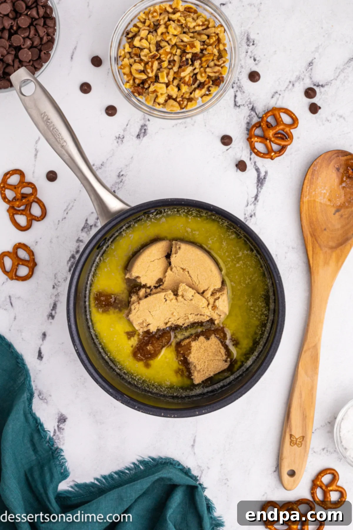 Twisted Toffee Treat 7 Brown sugar being stirred into melted butter in a saucepan, creating a caramelizing mixture.